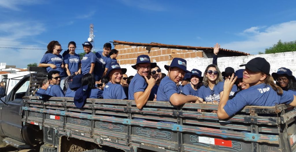 About 20 people in the back of a truck