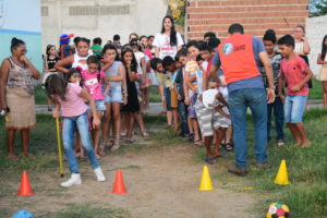 About 30 children in two lines ready for play