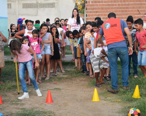 About 30 children in two lines ready for play